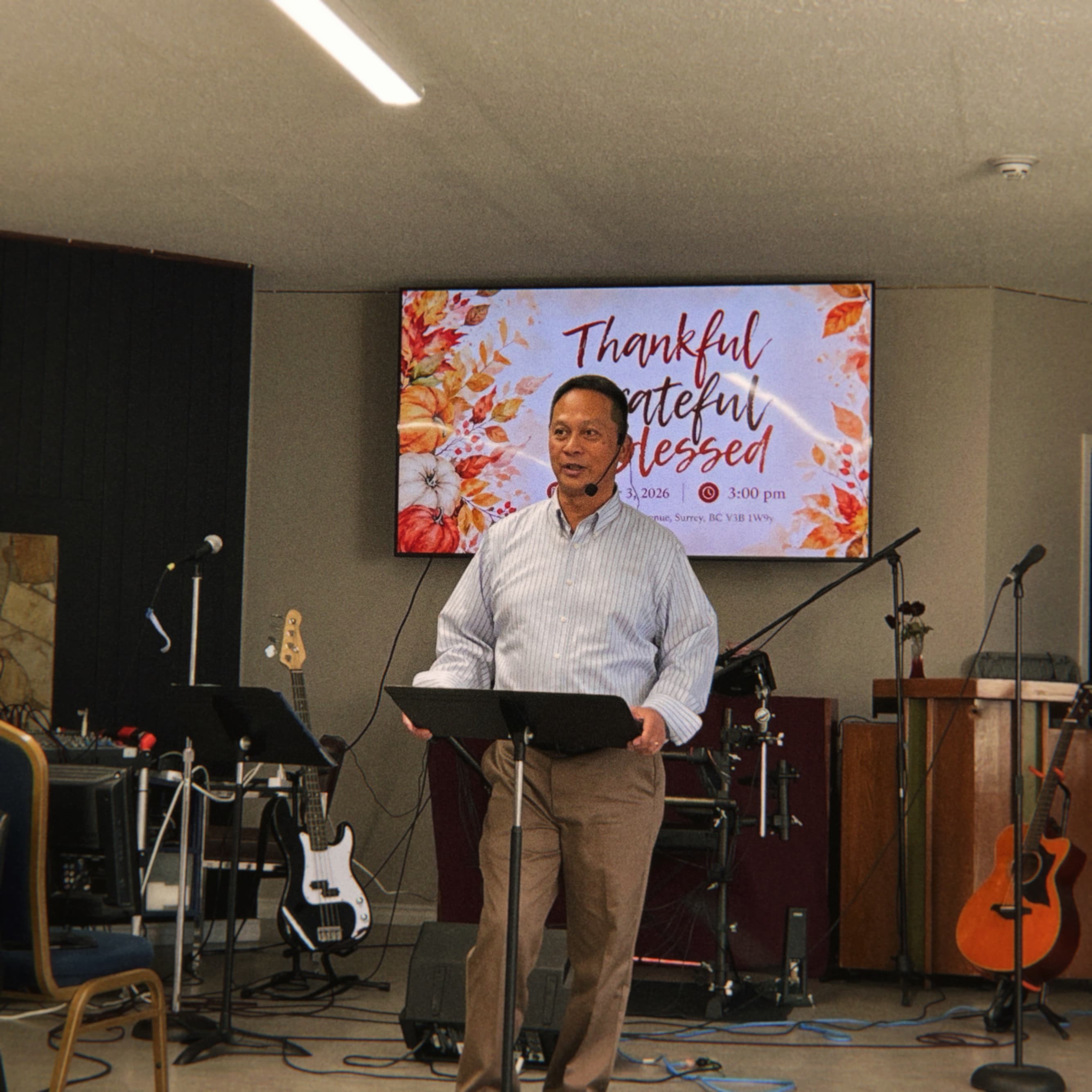 Pastor Dan Matias speaking behind a lectern at King’s Chapel Canada